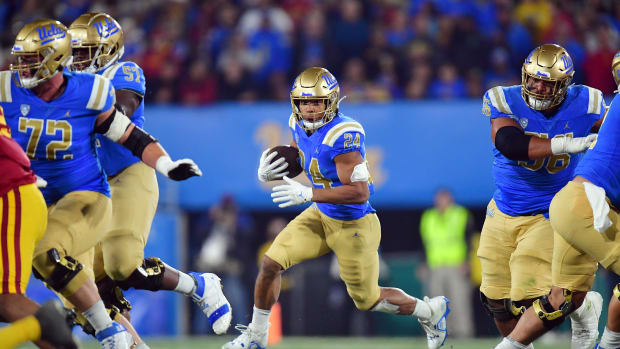 Nov 19, 2022; Pasadena, California, USA; UCLA Bruins running back Zach Charbonnet (24) runs the ball against the Southern California Trojans during the first half at the Rose Bowl. Mandatory Credit: Gary A. Vasquez-USA TODAY Sports
